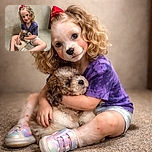 A cheerful little girl with curly hair tied with a bright red bow is sitting cross-legged on a speckled floor, hugging an adorable fluffy puppy. She's wearing a purple tie-dye shirt, shorts, and shiny rainbow sneakers, with a warm smile lighting up her face against a plain marble wall background.