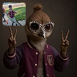 A confident young girl sporting funky star-patterned sunglasses flashes double peace signs while standing on a sidewalk near a grassy patch, with a backpack and a colorful cup nearby, radiating playful energy on a sunny day.
