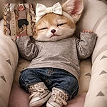 A tiny monarch of naptime is ruling the crib — bow headband, braided bumper throne, denim pants and leopard-cuffed sneakers included. Shot from above with soft warm light, the baby is blissfully asleep like a tiny, adorable CEO of cozy.