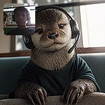 Two kids lean into the camera like a tiny podcast duo, with one wearing an oversized gaming headset and the other looking ready to deliver the world’s most serious sofa-side announcement. Bright windows behind them create a dramatic backlit glow.