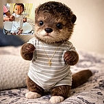 A cute baby dressed in a striped onesie and socks is standing on a bed with the help of an adult holding their hands. The baby looks curious with big eyes and a slight smile, while the room in the background features a mirror reflecting part of the scene and cozy bedding with pillows and a hairbrush nearby.