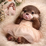 A tiny, wide-eyed newborn lounges on an ultra-fluffy cream blanket in a pale pink frilly dress, pacifier firmly in place, flanked by a wooden 'One Month' milestone sign and a halo of blush roses — the whole scene looks like a couture baby photoshoot staged inside a cloud.