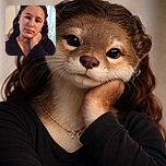 A thoughtful young girl poses indoors with her hand gently resting on her neck, soft natural light filtering through a window behind her, creating a calm and intimate portrait.
