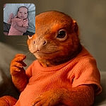 A sleepy baby in a peach-colored onesie lies on a bed with a light blue sheet, looking curiously at the camera with tiny hands in motion, capturing a candid moment of early life.