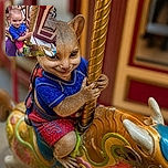 A delighted little carousel captain grips the golden pole like a tiny amusement-park hero, proudly riding a wonderfully overdecorated wooden horse while an adult and the carousel mirrors photobomb the adventure.