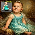 A joyful baby in a bright turquoise dress sits happily on a black trampoline outdoors, surrounded by a playful backyard scene with swings, tires, and greenery, capturing pure innocence and curiosity.