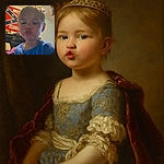 A young child puckers up for a selfie with a playful expression, wearing a blue shirt adorned with cute cats. The background shows a cluttered room with a Confederate flag hanging on the wall, adding an unexpected twist to the cozy indoor scene.