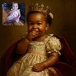A charming toddler in a colorful floral dress sits on a wooden floor with a playful expression, nibbling on a snack, while sporting a cute bow in her hair and sparkling earrings, next to a black leather couch.