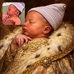 A peaceful newborn baby is sleeping soundly, wearing a cute striped hat with soft lighting highlighting the delicate features and tiny hands gently resting on the chest.