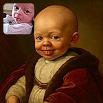 A close-up photo of a baby sticking out their tongue with wide eyes, wrapped in a white garment, sitting comfortably with a couch in the background.