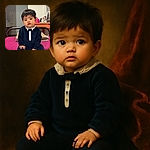 An adorable baby dressed in a navy blue velvety outfit with a white collar and bow tie sits on a magenta bedspread, looking curiously at the camera with big, round eyes. The background shows a cozy room with a makeup table, some hats hanging on the wall, and folded towels neatly placed behind the baby.