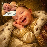 A heartwarming close-up of a smiling newborn baby peacefully resting on an adult's arm, with a cozy home background softly blurred. The baby's joyful expression and tiny hands create a tender and adorable moment.