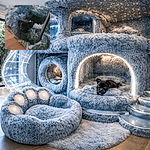 A tiny black puppy burrowed into a shaggy blue rug, peeking up with curious eyes and a little bow — looks like it claimed the fluffiest throne in the house.