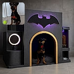 A cute puppy sitting attentively on a tiled floor next to a bright yellow tennis ball, wearing a collar with a red poppy tag, ready for some playful fun.