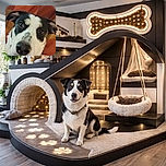 A close-up photo of a curious black and white dog with expressive eyes and a shiny chain collar, lounging on a colorful geometric patterned blanket, looking straight into the camera with a gentle, inquisitive expression.