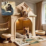 A charming French Bulldog lounges comfortably on a plush gray pet bed, intensely chewing on a dark, textured chew toy. The cozy indoor setting features light wooden flooring and modern white chairs in the background, creating a warm and inviting atmosphere for this determined little chewer.
