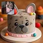 A small dog with a brindle coat and large ears is standing on its hind legs, wearing a cozy pink hoodie, looking curiously over a gray surface in a dimly lit room with wooden floors and some furniture.