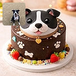 A sandy-nosed black-and-white dog sits center-frame on a wide stretch of beach, grinning with a sand-speckled snout and eager eyes — clearly proud of whatever prehistoric treasure it just dug up. The empty sandy background makes this pup the undeniable star of the show.
