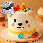 A cute white dog with a black shirt lounges on a green bedspread decorated with whimsical illustrations and text, looking off to the side with a calm and curious expression.