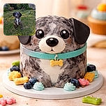 A charming young dog with a unique speckled coat sits attentively on a grassy backyard, surrounded by scattered leaves and garden plants, soaking in the warm sunlight.
