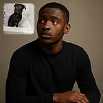 A sleek black dog sitting patiently in a white bathtub, looking slightly off to the side with curious eyes. The bathroom setting is simple with a purple floral shower curtain partially visible, and the lighting is soft but a bit dim, giving a candid and cozy vibe.