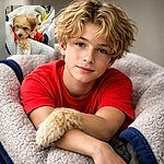 A curly-haired puppy in a red sweater is nestling into a fluffy sherpa blanket like it's claiming first-class comfort — one paw draped over the edge and a sleepy, suspicious side-eye toward the camera while a shopping cart and yellow tag peek in the background.