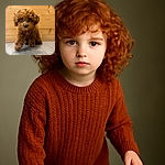 A fluffy, curly-haired brown puppy is stepping forward on a wooden floor with a wooden wall background, looking adorably curious with big shiny eyes. The soft focus and warm tones add to the cozy, heart-melting vibe.
