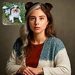 A stunning fluffy dog with striking blue eyes lounges gracefully on a patch of grass, looking directly at the camera with an expression of calm curiosity amidst a natural outdoor setting.