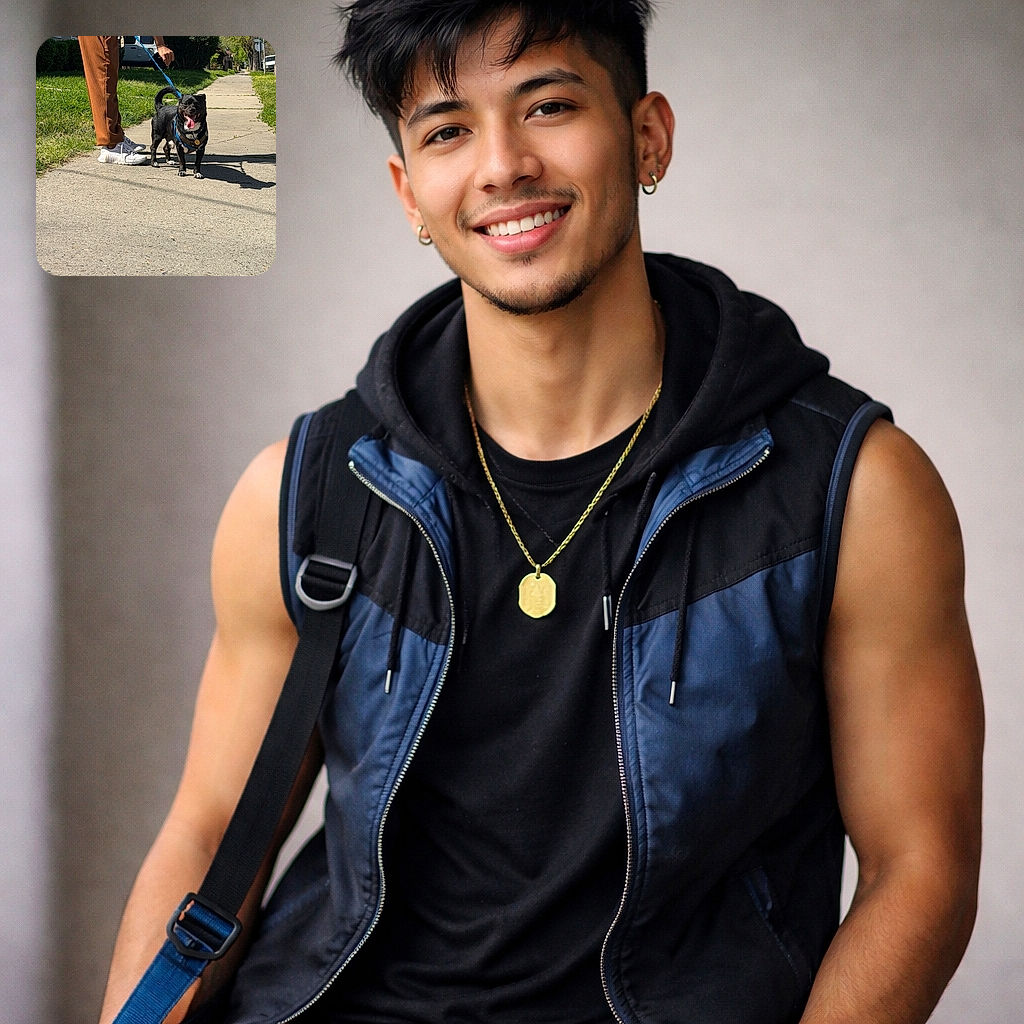 A happy black dog with its tongue lolling out stands proudly on a sunny sidewalk, sporting a blue leash and harness while its human holds the other end just out of frame — suburban houses, green lawns and trees line the background as the pup soaks up the walk.