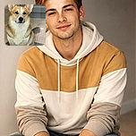A dignified corgi sits patiently behind a glass door, looking like it's judging your life choices with those big, expressive eyes and perky ears. The cozy indoor setting adds a homey vibe to this canine portrait.