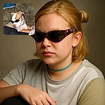 A cool dog rocking a pair of sunglasses indoors, lounging on a couch with a casual vibe, as if ready to hit the beach but stuck in the living room.