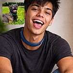 A happy dog lounges on a vibrant green lawn, basking in the sunlight with its tongue out and ears perked, looking like the ultimate grass enthusiast enjoying a perfect day outdoors.