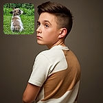 A charming little puppy sitting on lush green grass, looking back with curious eyes, ears perked up as if ready for an adventure in the garden.