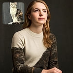 A majestic cat sits proudly on a soft, round perch, gazing upwards as if contemplating the mysteries of the universe, with sunlight highlighting its fluffy fur and creating a serene atmosphere.