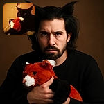 A dimly lit photo of a black cat clutching a red and white plush toy in its mouth, with a soft beige background and a hanging ID badge casting a shadow above.