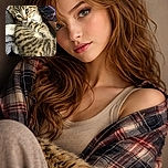 A cozy close-up of a fluffy tabby kitten with expressive eyes, nestled comfortably on soft blankets and a plaid fabric background, radiating pure cuteness and warmth.