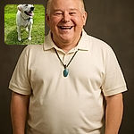 A happy yellow Labrador Retriever standing on a green lawn with a slightly blurred background including a road and parked cars. The photo appears to be a screenshot from a phone gallery with date and location details visible at the top.