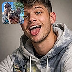 A bossy French bulldog photobombs a selfie, hogging the frame with tongue-out enthusiasm while its owner lurks in the background like a dignified sidekick under a perfect blue sky and a swing chain cameo.