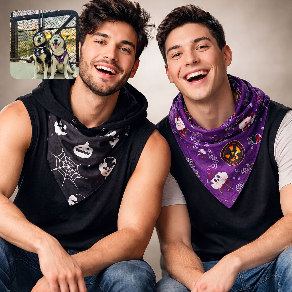 Two happy huskies wearing festive Halloween bandanas pose in front of a chain-link fence adorned with colorful locks, with a beautiful sunset reflecting off the water behind them. Their smiles and the glowing sky create a warm, joyful scene.