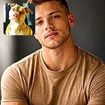 A close-up photo of a light brown dog with a white chest sitting against a dark background with patches of sunlight. The dog's expression is calm and attentive, though the photo is slightly overexposed in the chest area, reducing some detail.