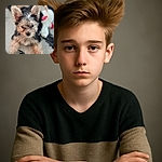 A tiny, wet-furred puppy stares curiously into the camera with big, perky ears and shiny eyes, sitting on a textured rug with a blurred white and red plush toy in the background.