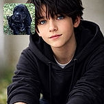 An adorable black puppy with shiny fur and soulful eyes sits on a patch of green grass, looking curiously upwards as if plotting its next playful adventure.