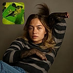 A fluffy tabby cat is stretching out luxuriously on a green cushion atop a yellow couch, bathed in warm yellow light that gives the whole scene a cozy, slightly surreal vibe.
