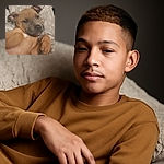 A sleepy puppy lounging on a fluffy blanket, looking like it's caught mid-yawn or about to drift off into a cozy nap. The photo is a bit soft in focus, adding to the relaxed, dreamy vibe.