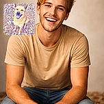 A cheerful dog with big ears is sitting on a bed of dry autumn leaves, looking up with a happy, open-mouthed smile as if ready to share a secret or a fetch game.