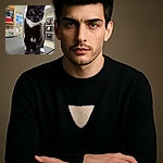 A curious tuxedo cat with bright green eyes sits on a textured surface in what appears to be a veterinary or clinical setting, with shelves and supplies in the background, giving an impression of a cat ready for a checkup or just plotting its next adventure.