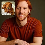 A charming golden retriever lounges comfortably on a bed with white sheets, looking directly at the camera with a happy expression and tongue slightly out, capturing a warm and cozy moment.