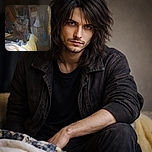 A fluffy black cat with glowing yellow eyes sits majestically on a bed covered with a yellow blanket, surrounded by household clutter including a flashlight and a mop, giving off a mysterious yet cozy vibe.