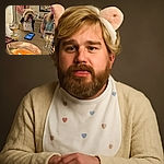 A cozy indoor scene where a fluffy dog wearing a bib and cute ear headband sits at a table with snacks, drinks, and a lit candle in the foreground, while a smiling woman with a tattoo looks on warmly, creating a charming and relaxed atmosphere.