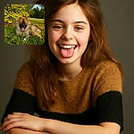 A fluffy, happy dog lounges on the grass with its tongue out, basking in the warm sunlight. The vibrant green foliage and clear blue sky create a perfect outdoor backdrop for this adorable pooch's chill session.